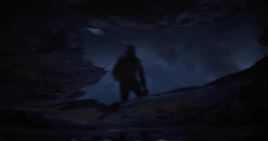 A person walks over a puddle on a street at night