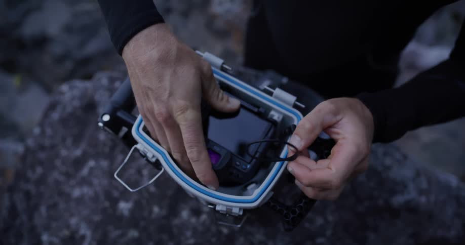 Camera is placed inside a waterproof box on a rocky surface