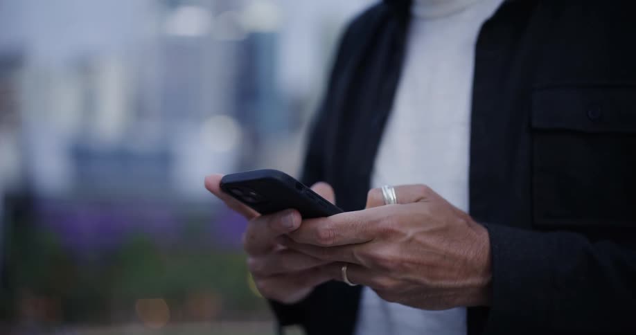 A man is texting on his cell phone