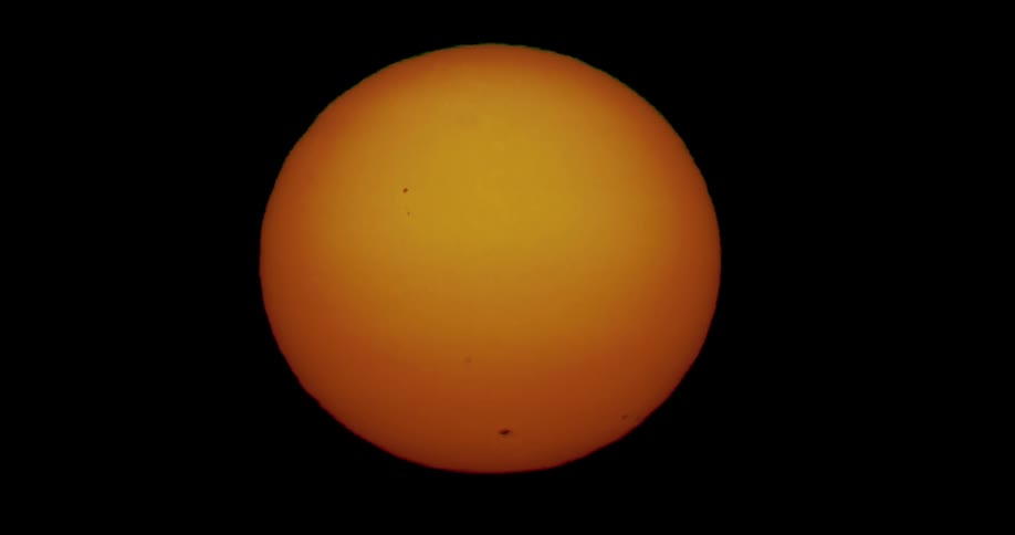 The yellow sun floats in the sky at dawn