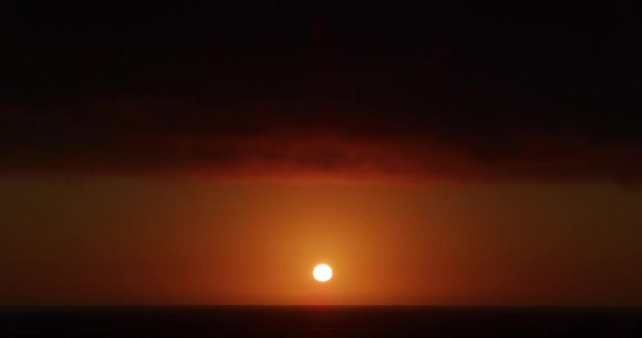 The sun is rising on the horizon