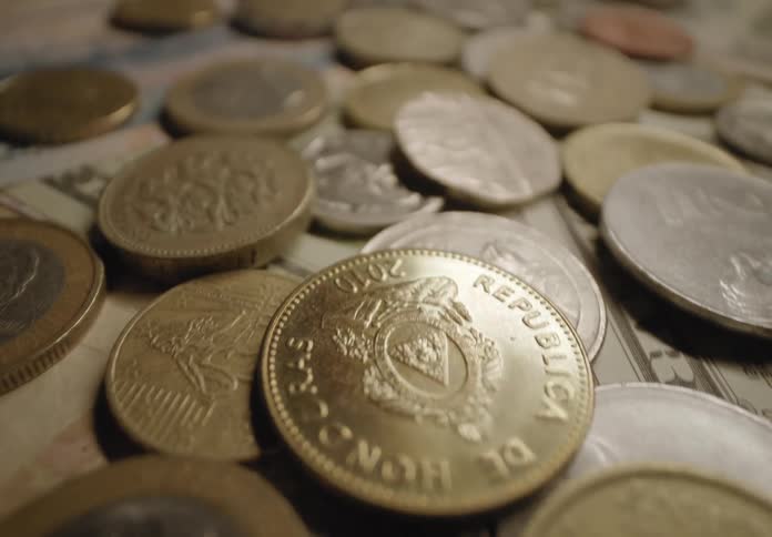 Money bills and coins over a surface indoors