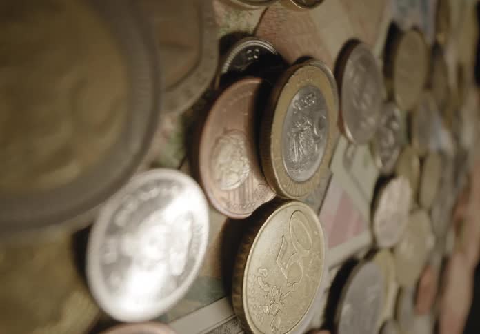 Money bills and coins over a surface indoors