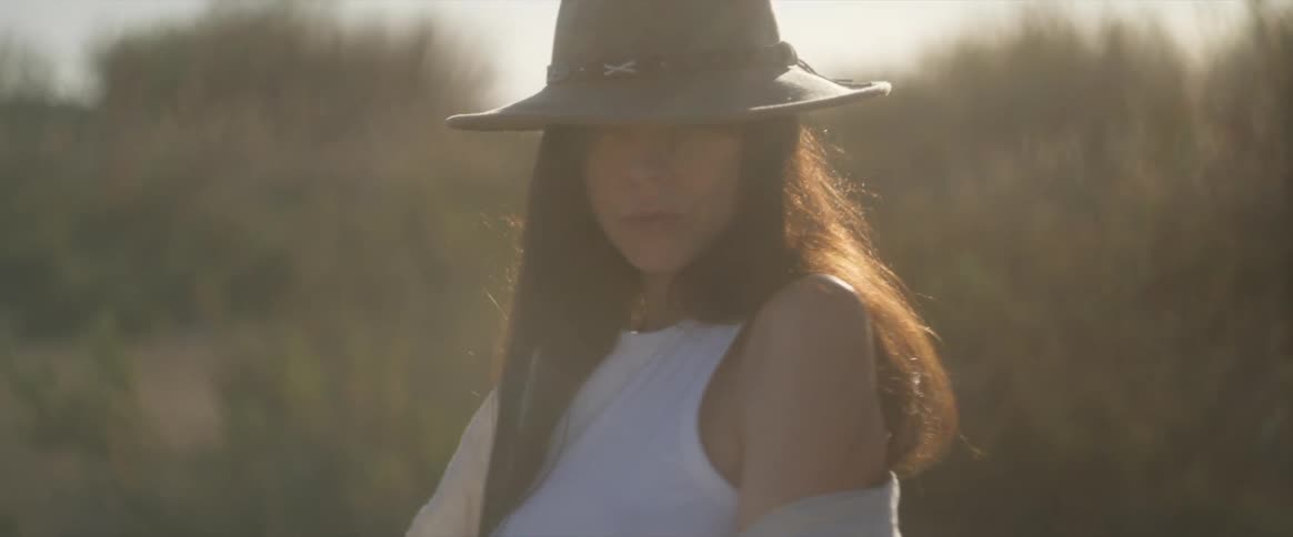A clip of a lady putting on a hat