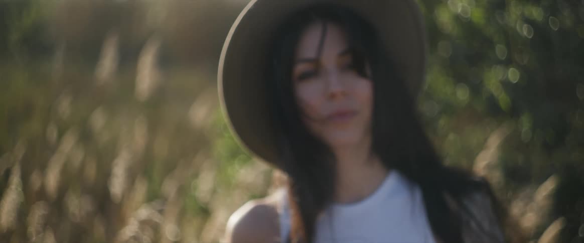 An image of a lady putting on an hat