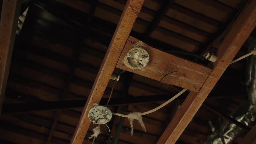 Light receptacles on an unfinished wood rafter
