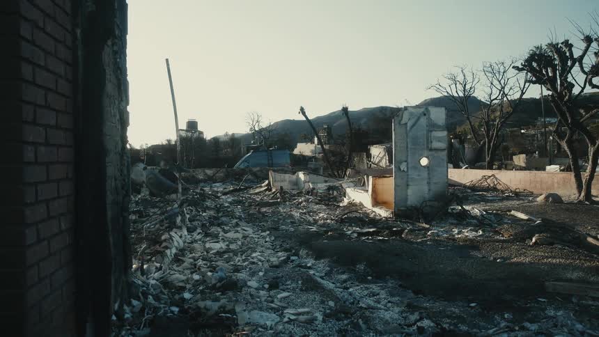 Postfire scene with destruction and mountains in the background