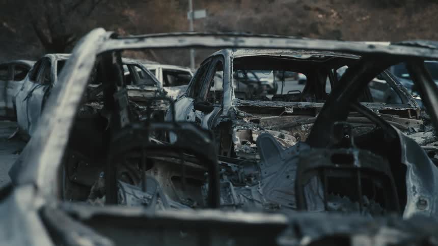 A clip of burnt and ruined cars