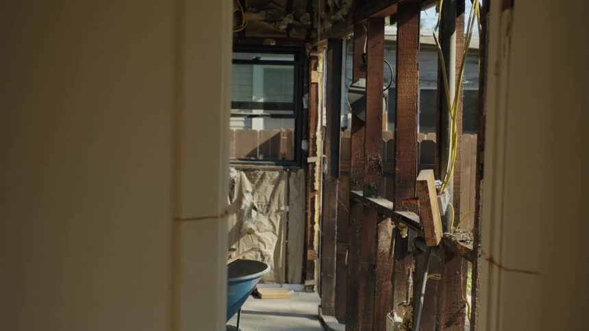 Wheelbarrow sits in the part of a home being remodeled