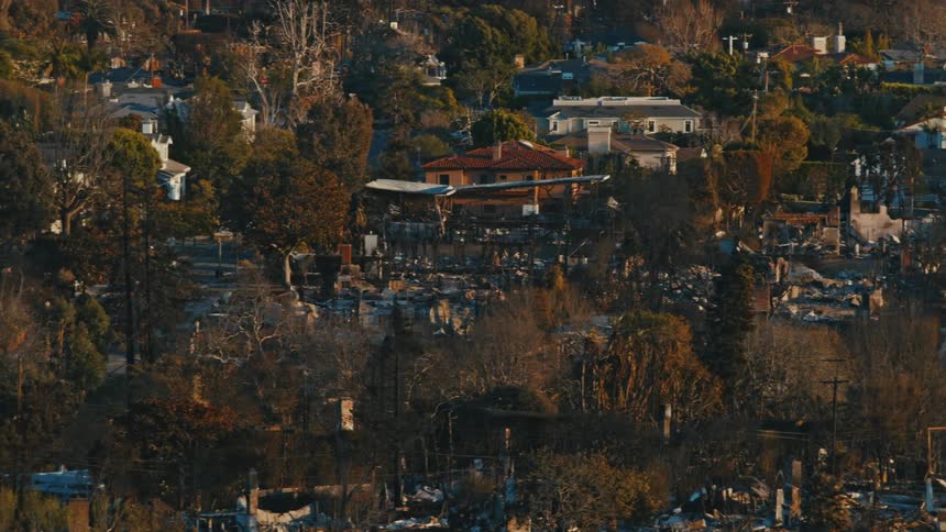 Residential neighborhood with destroyed areas and snow and scattered trees