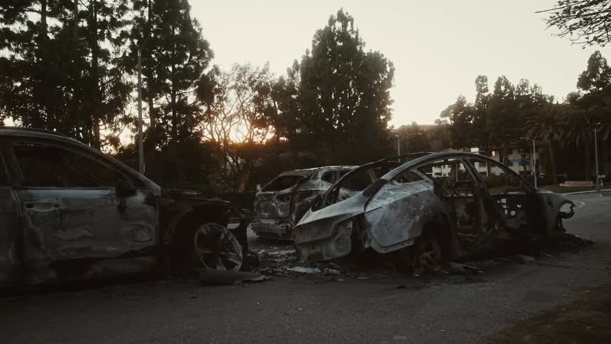 Three car carcasses stopped on a track