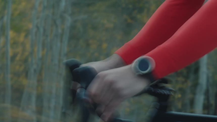 Cyclist pedaling outdoors with mountains in the background