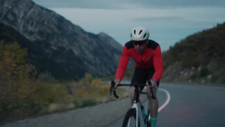 Man cyclist riding on a highway in a morning