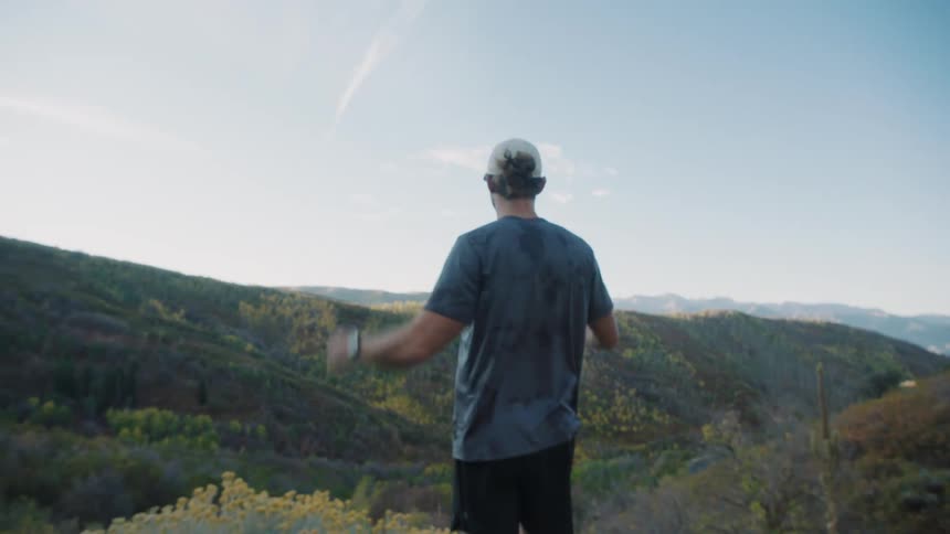 Man enjoying the view on a mountain with green vegetation