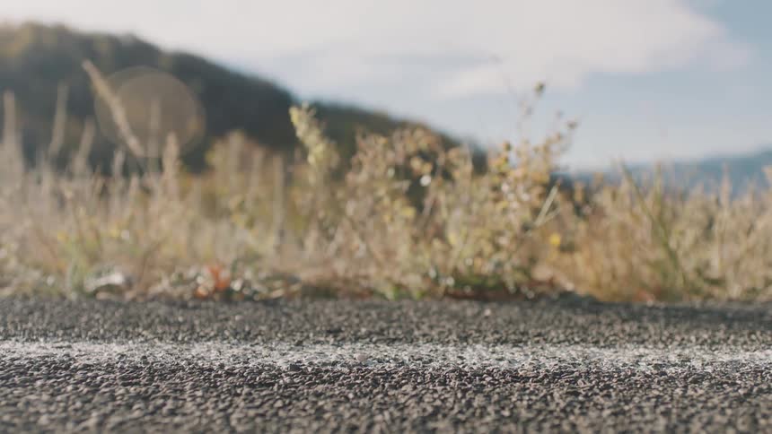 A person is jogging on a mountain road