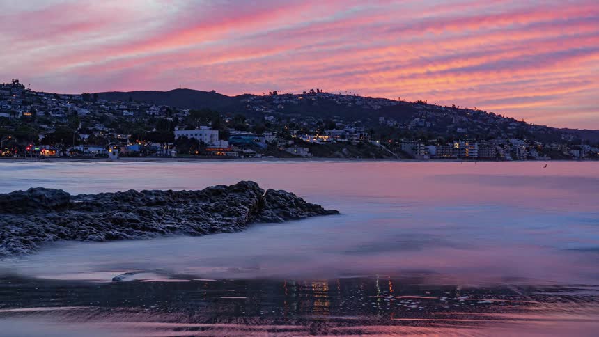 Homes line the shore at sunrise