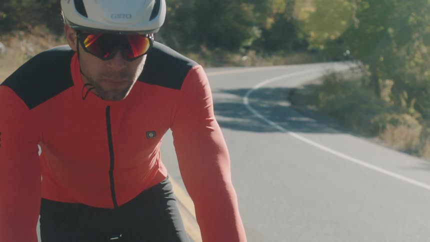 Man in white helmet cycling on a road during daytime