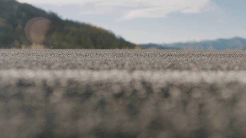 A white line is on the gravel of the road