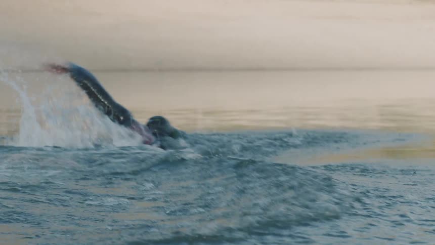 Man swimming in a calm lake