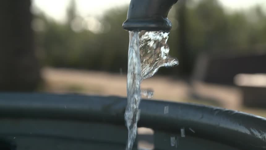 Water pours from an outdoor spout