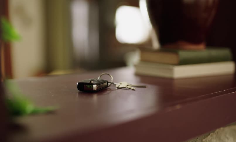 Man walks across the room and picks up his car keys