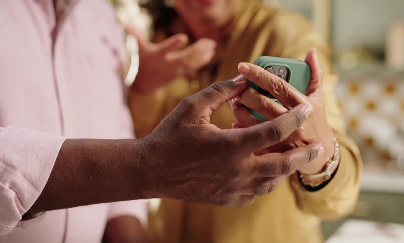 A clip of people having a conversation while holding a smartphone together