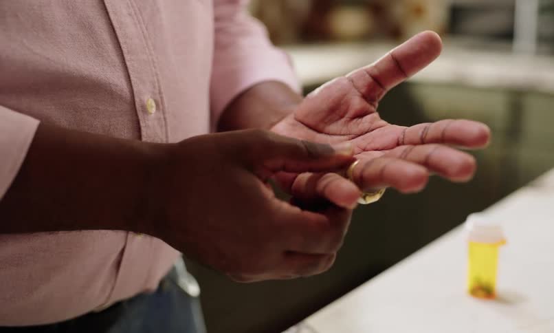 A persons hand using their finger to massage their other hand