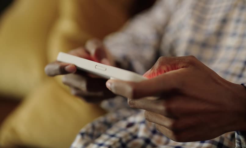 Pair of hands holding and interacting with a smartphone