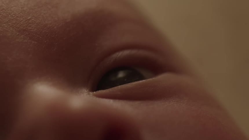 A closeup of a babys eye and part of the face