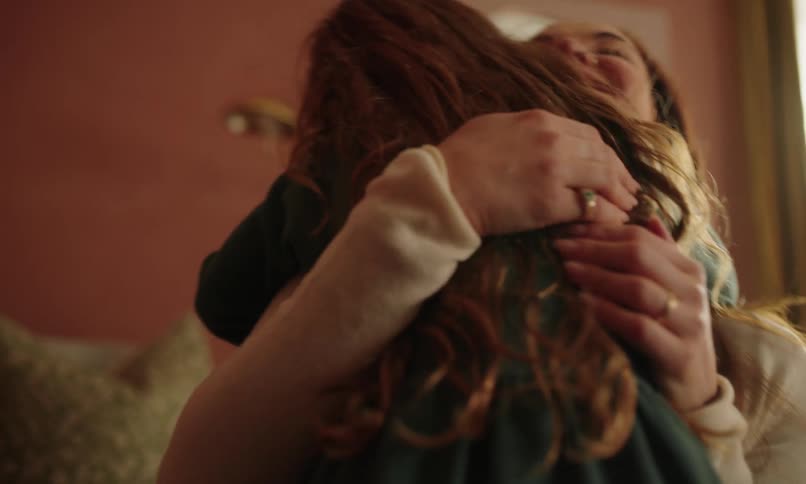 Girl running down the hallway and hugging her mother lovingly
