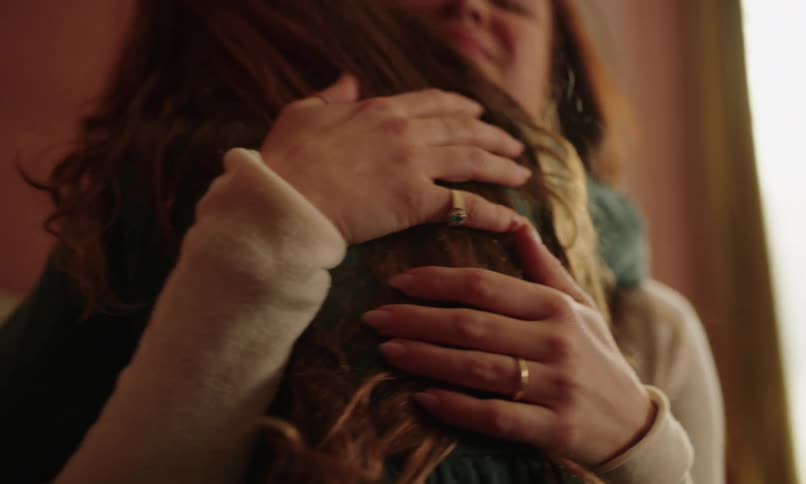 Mother lovingly hugging her little daughter