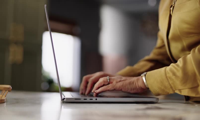 Pair of hands typing on a laptop