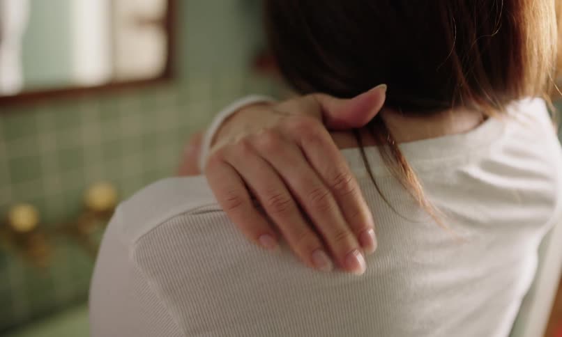 A back clip of a female wearing a white shirt