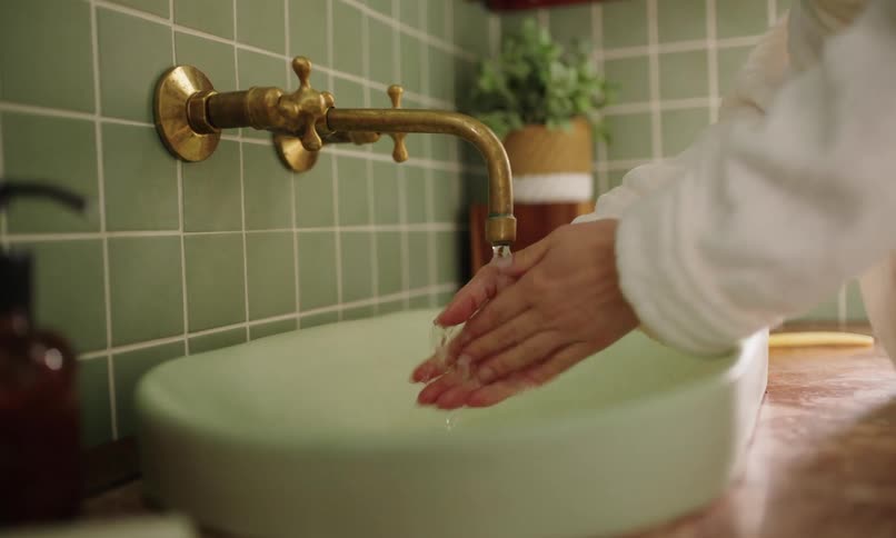 A clip of a person washing hands in the bathroom