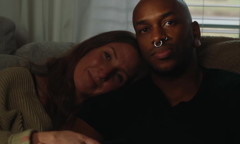 Couple sitting on the couch watching together in a romantic way