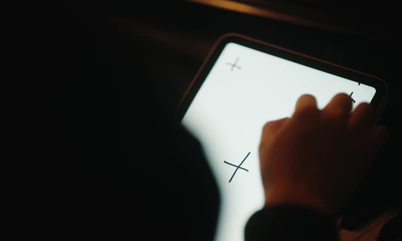 A person picks up their tablet and uses it