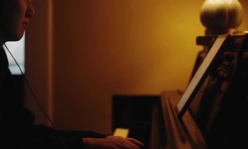 An image of a person playing a keyboard