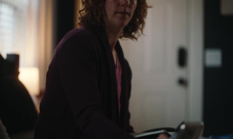 Woman sitting writing in a notebook