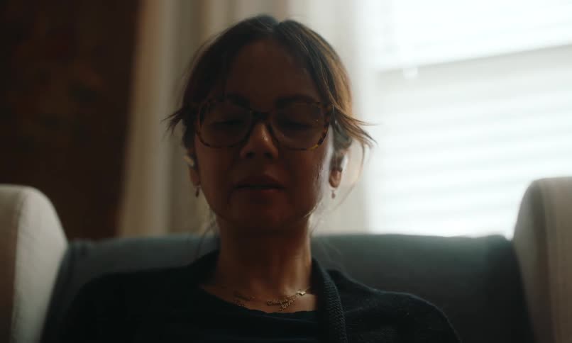 Woman sitting in an armchair drinking a mug and relaxing her head