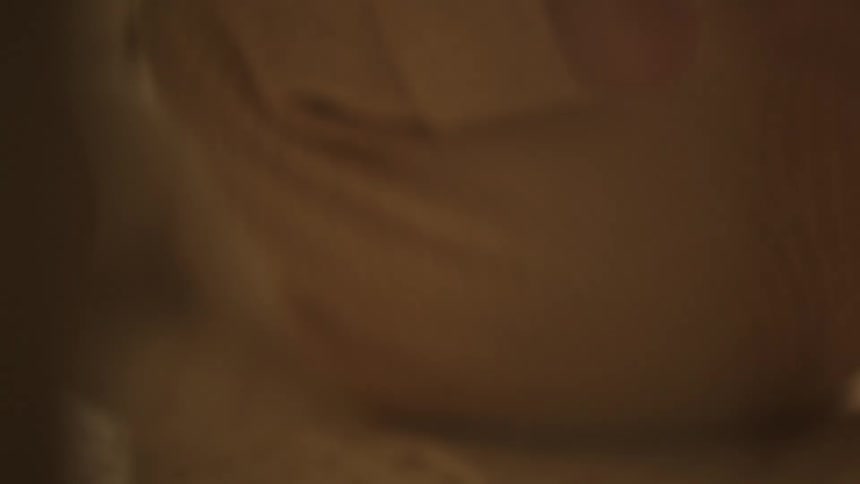 A baby is kicking his feet in the crib
