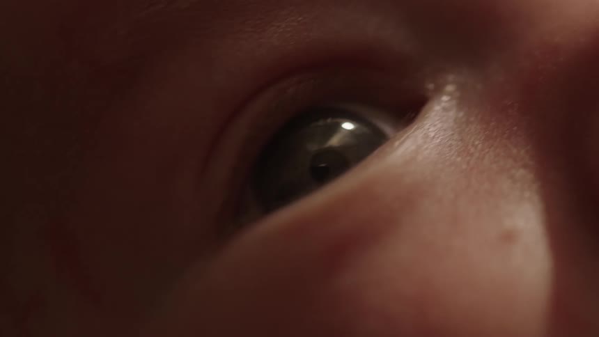 A baby slowly blinks its eye