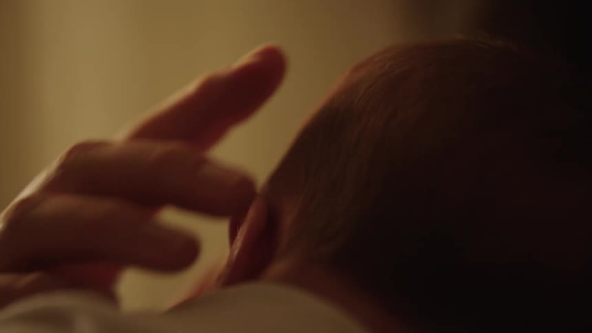 Mother caresses her sleeping child