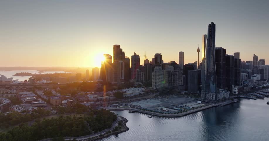 Aerial view of a cityscape next to a lake at sunrise