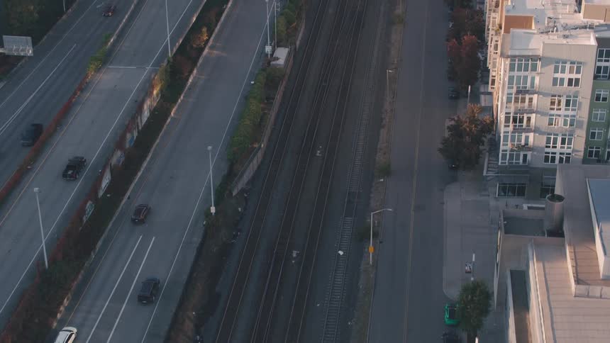 Aerial view of a highway with vehicle traffic on a train track