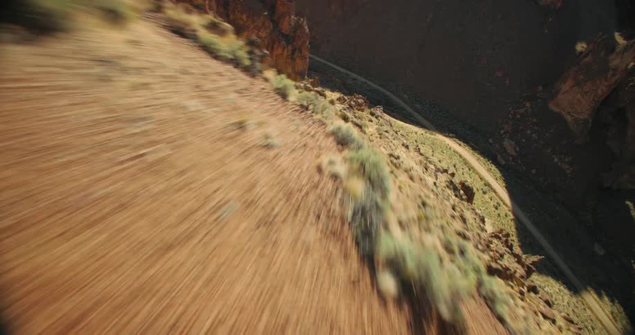 Aerial view of canyons and a narrow dirt road