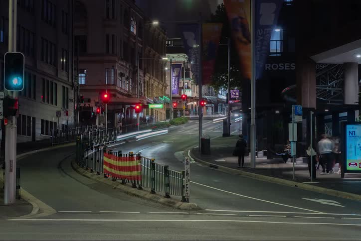 Busy street with vehicle and pedestrian traffic at night