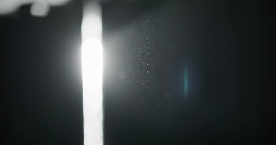 Abstract light beam passing through a metal