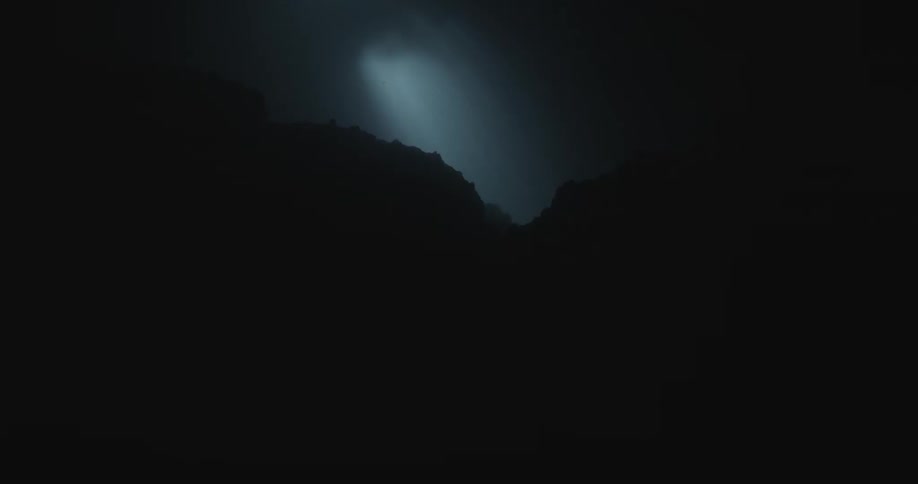 A line shines under the very dark waters