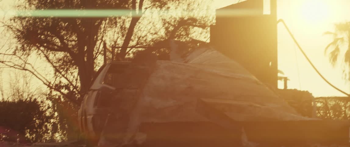 Some concrete debris on the ground and a strong orange light illuminating the environment