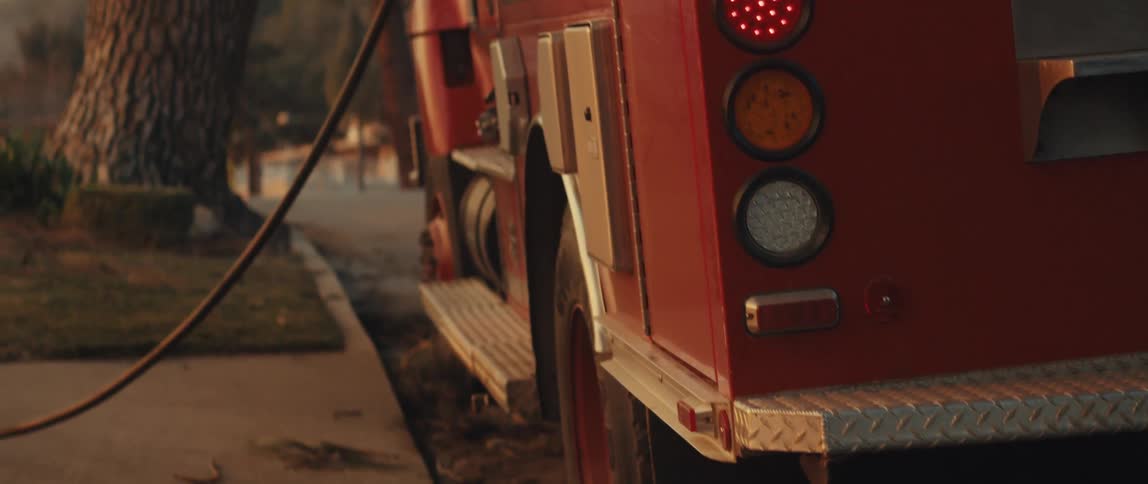 A hose is coming out of the fire truck